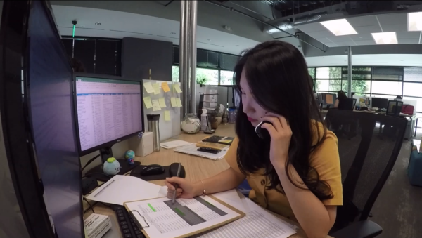 Yuna on the phone helping at Alliance Abroad