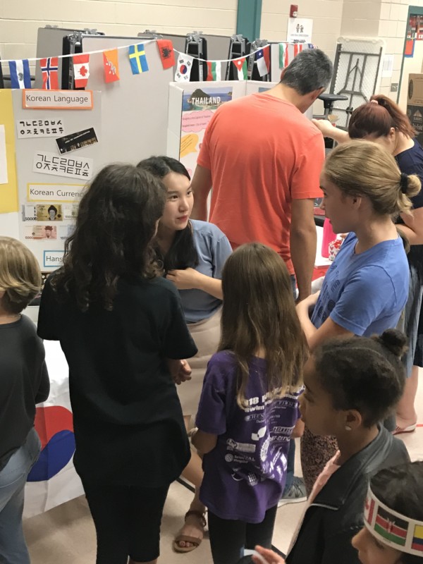 Yuna talking with children at Austin School's World Day event